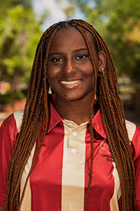 smiling female student with long red-tinted braids