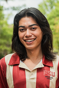 smiling student with shoulder-length brown hair