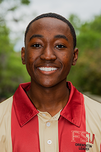 smiling male student with close-cropped brown hair