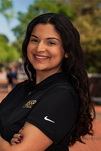 smiling female student with long wavy black hair 