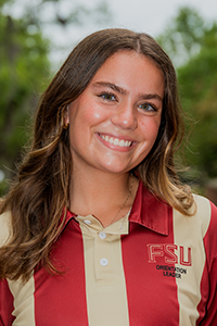 smiling female student with long brown hair with blonde lighlights and feathering