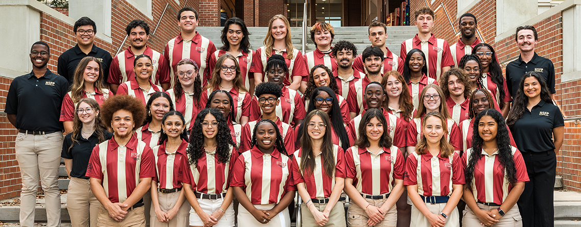 orientation leaders standing in a group by the Health and Wellness stairs